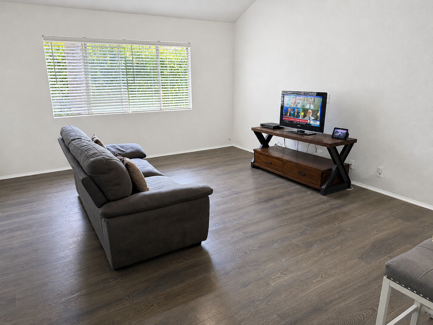 Living room with updated flooring and natural light