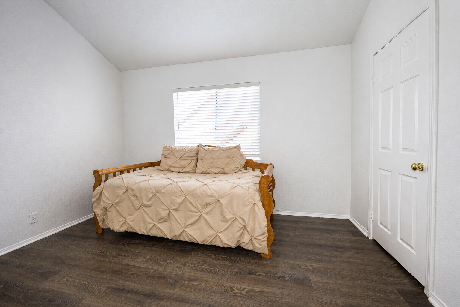 Bedroom with wide-plank flooring and neutral finishes